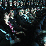 people in theatre in 3D glasses